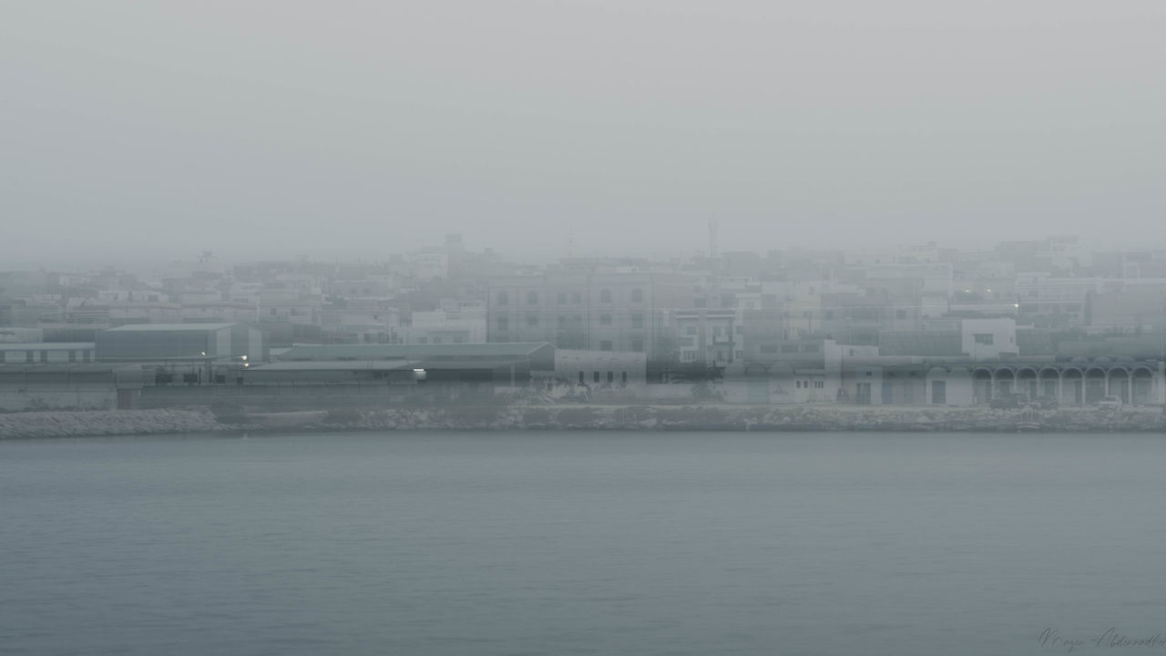 VIEW OF SEA AND BUILDINGS AGAINST SKY