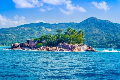 Scenic view of sea and mountains against sky