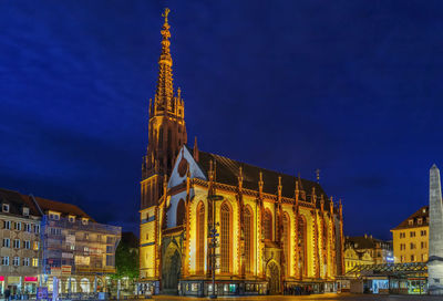 Low angle view of illuminated building against sky at night