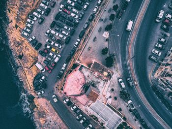 High angle view of cars parked on street amidst buildings in city