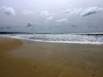 Scenic view of sea against cloudy sky