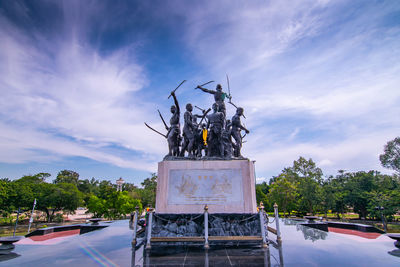 Low angle view of statues against sky