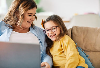 Happy woman using phone at home