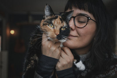 Portrait of beautiful young woman with cat