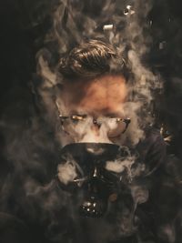 Close-up of man with smoke