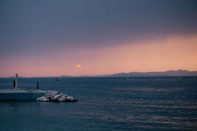 Scenic view of sea against clear sky during sunset