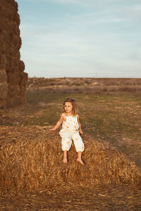 Full length of girl on field against sky