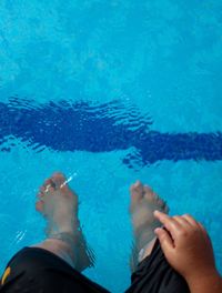 High angle view of man standing in swimming pool