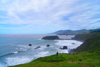 Scenic view of sea against cloudy sky