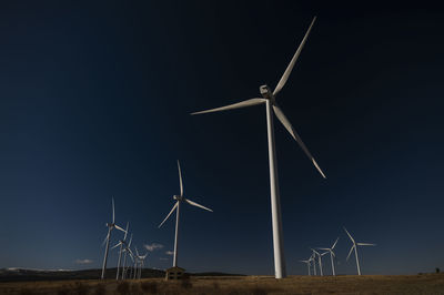 Modern windmills on field against blue sky. shot in castilla la mancha, spain