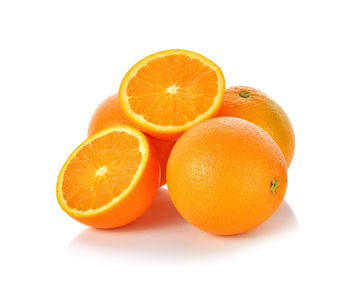 Close-up of orange fruit against white background