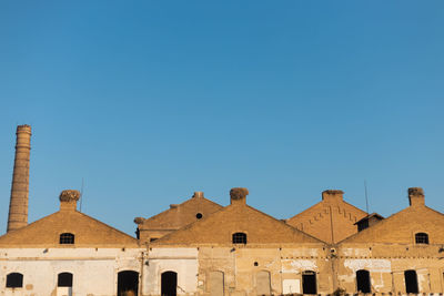 Low angle view of buildings against blue sky