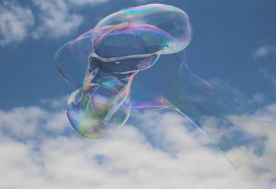 Low angle view of bubbles against sky