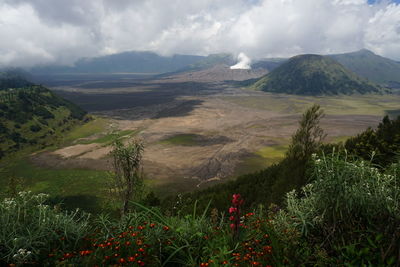 Scenic view of mountains against cloudy sky