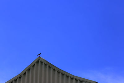 Low angle view of building against blue sky