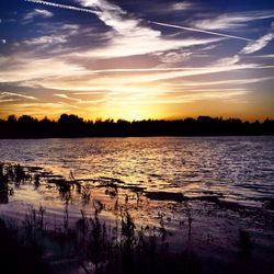 Scenic view of lake at sunset