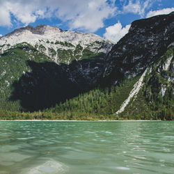 Scenic view of lake by mountains against sky