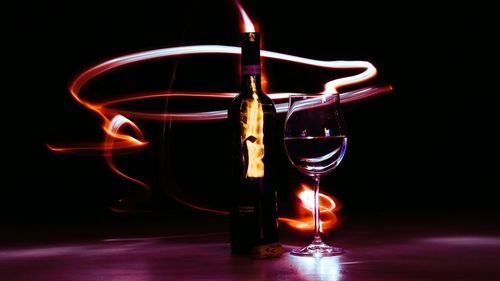 Long exposure of wine with burning flame on table