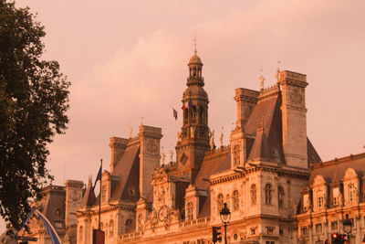 Low angle view of buildings against sky during sunset