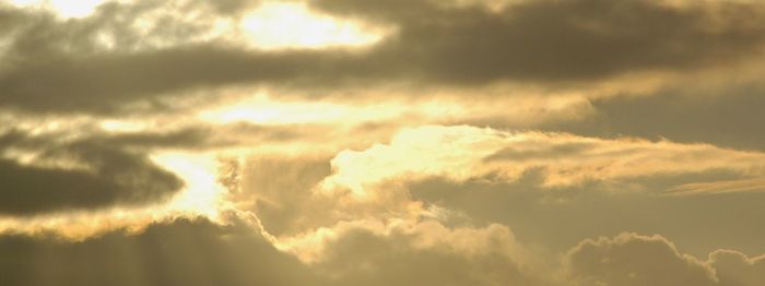 Low angle view of cloudy sky at sunset