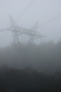 Low angle view of electricity pylon against sky