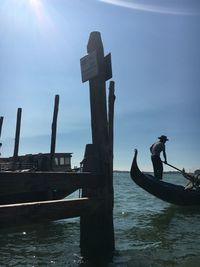 Men in boat against sky