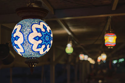 Blue traditional  lamp, selective focus, blurred background, popular souvenir lanterns, evening cafe