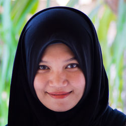 Close-up portrait of smiling woman wearing hijab