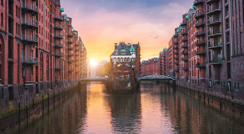 Bridge over canal amidst buildings in city