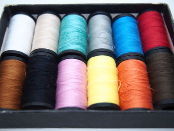 Close-up of multi colored thread spools