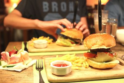 Close-up of burger with french fries on table