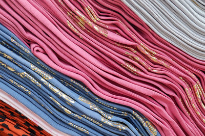 Detailed close up view on samples of cloth and fabrics in different colors found at a fabrics market