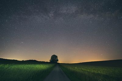 Scenic view of field against sky at night
