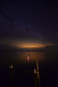 Scenic view of lake against sky at night