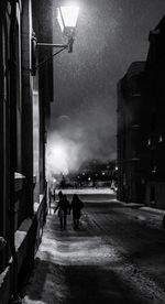 People on street in city at night