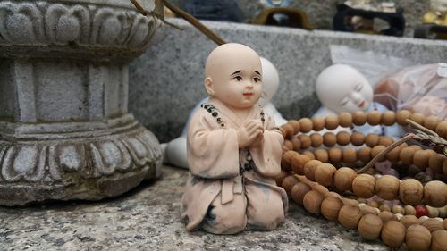 Close-up of buddha statue against building