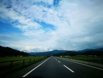 Road by landscape against sky