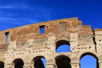 Low angle view of old ruins against clear blue sky