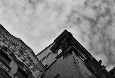 Low angle view of building against cloudy sky