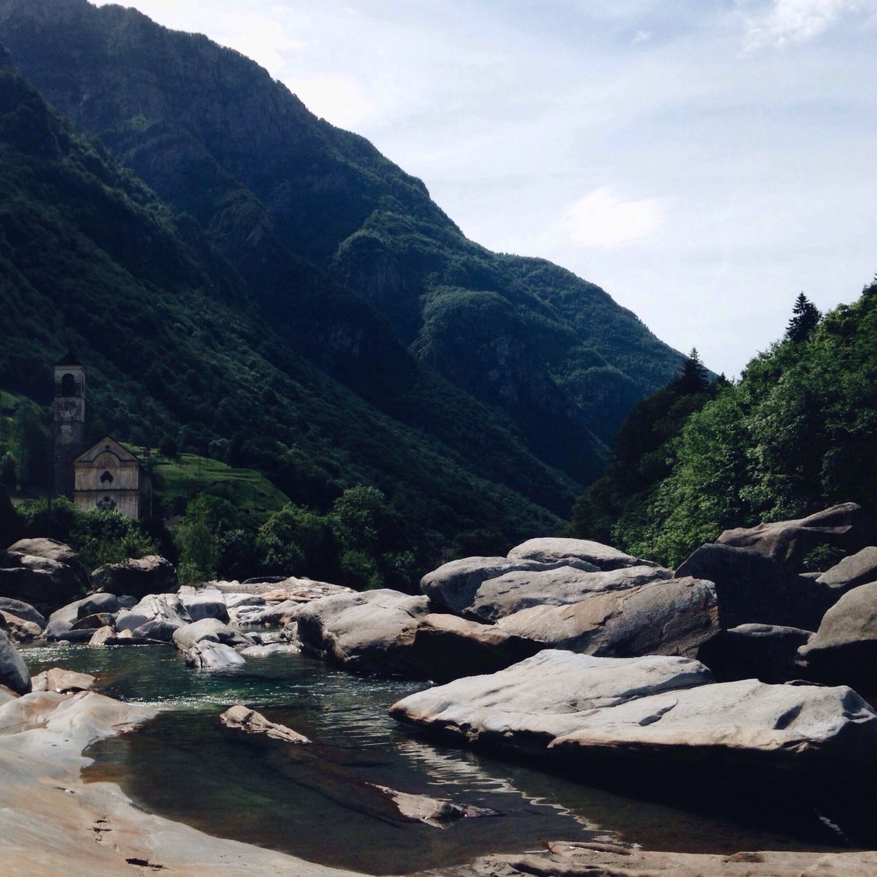 mountain, scenics, tranquil scene, sky, tranquility, beauty in nature, mountain range, nature, rock - object, water, landscape, tree, non-urban scene, day, cloud - sky, idyllic, outdoors, cloud, river, hill