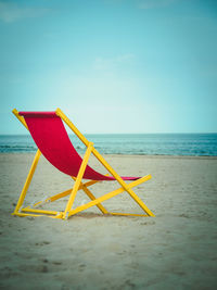 Umbrella on beach against sky