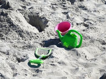 High angle view of sand pail and shovel at beach