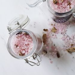 High angle view of bath salts in jars on table