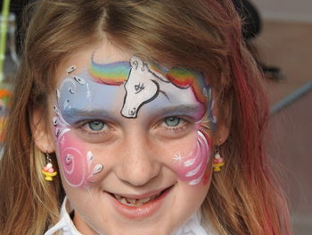 Close-up portrait of smiling girl with face paint