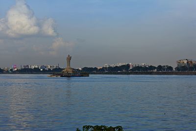 Scenic view of sea by buildings in city