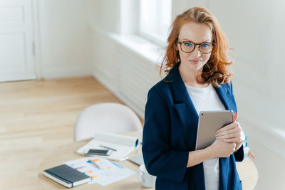 Portrait of businesswoman standing in office