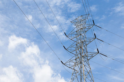 Low angle view of electricity pylon against sky