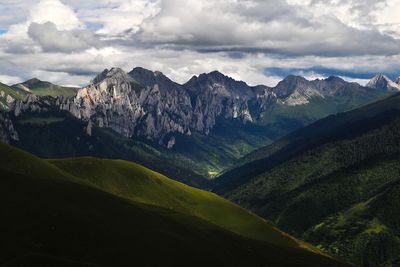 Scenic view of mountains against cloudy sky