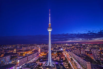 High angle view of city lit up at night