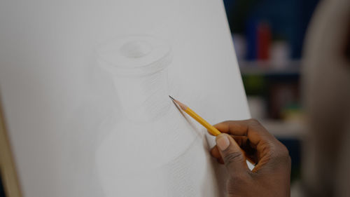 Close-up of human hand holding paper